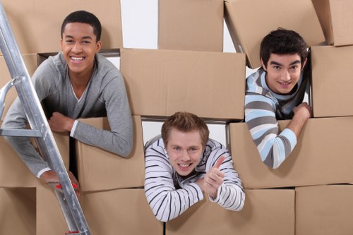 Piano moving team handling an upright piano in Bermondsey