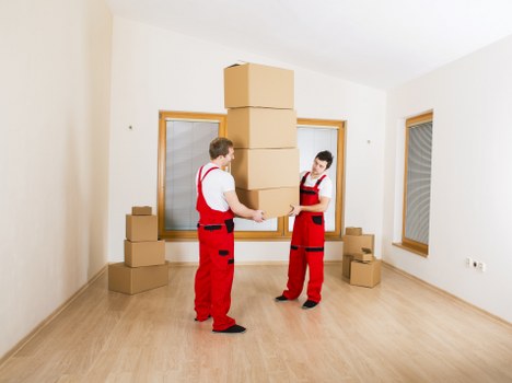 Local movers handling furniture in a Bermondsey apartment block