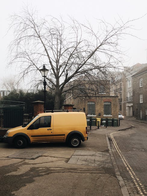 A yellow commercial van operated by Man and Van Bermondsey is parked on a residential street in Southwark, with the vehicle positioned close to a pavement and a leafless tree. The van is situated near